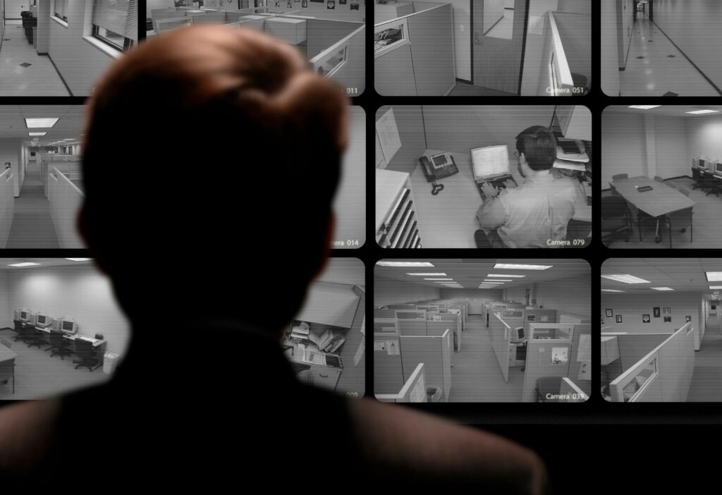 A person monitoring surveillance cameras