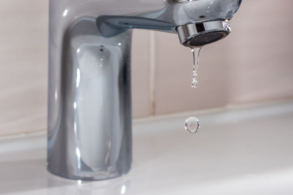 Close up shot of water coming out from the tap