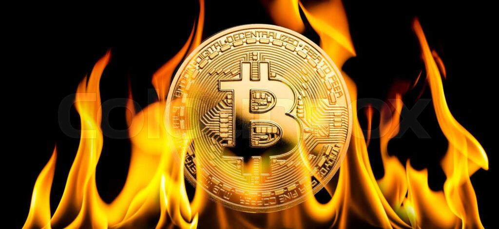 A burning bitcoin with black background