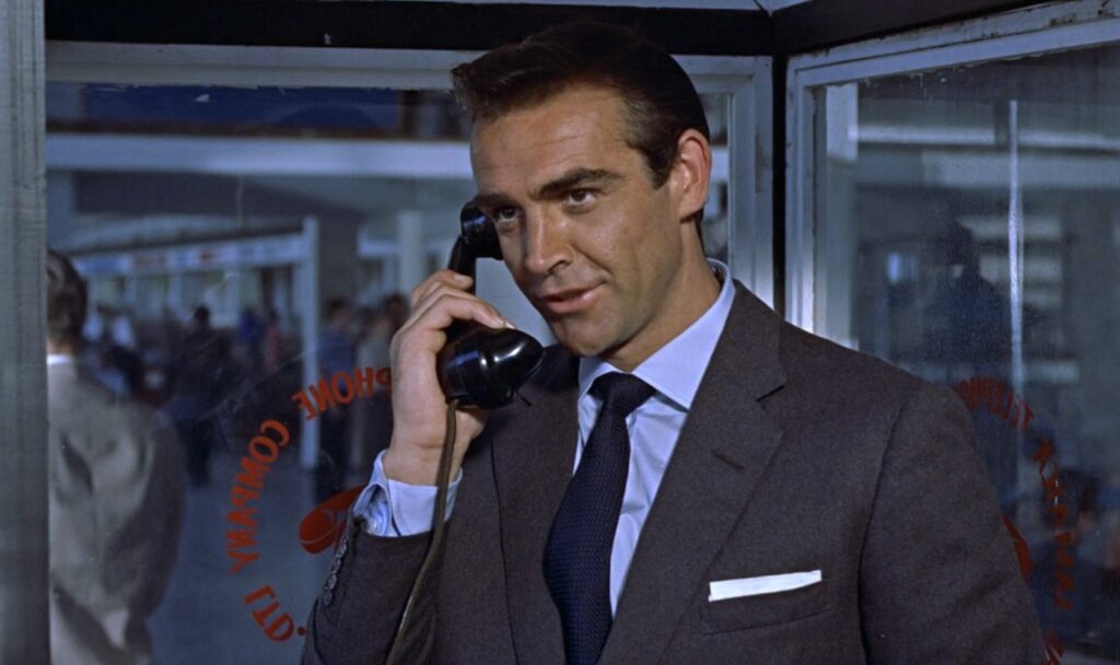 Sean Connery on the phone in a gray suit