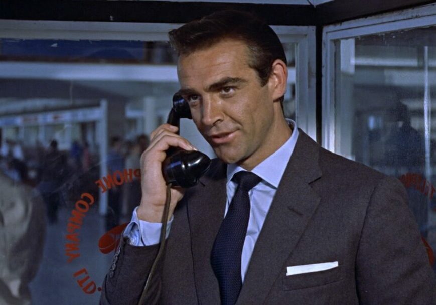 Sean Connery on the phone in a gray suit