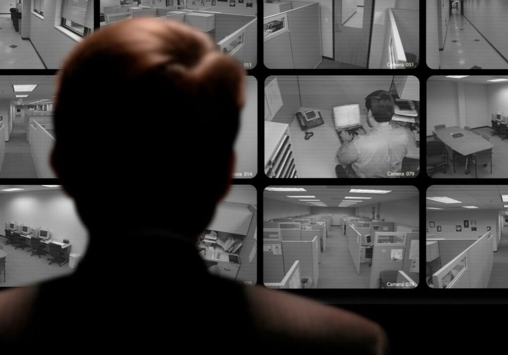 A person monitoring surveillance cameras