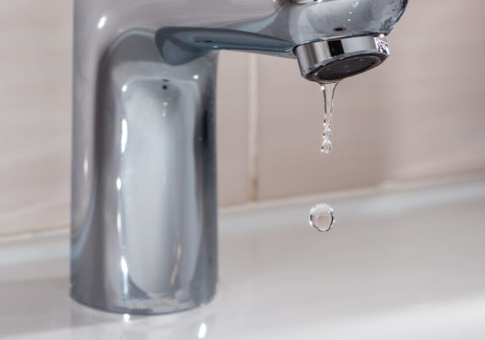 Close up shot of water coming out from the tap