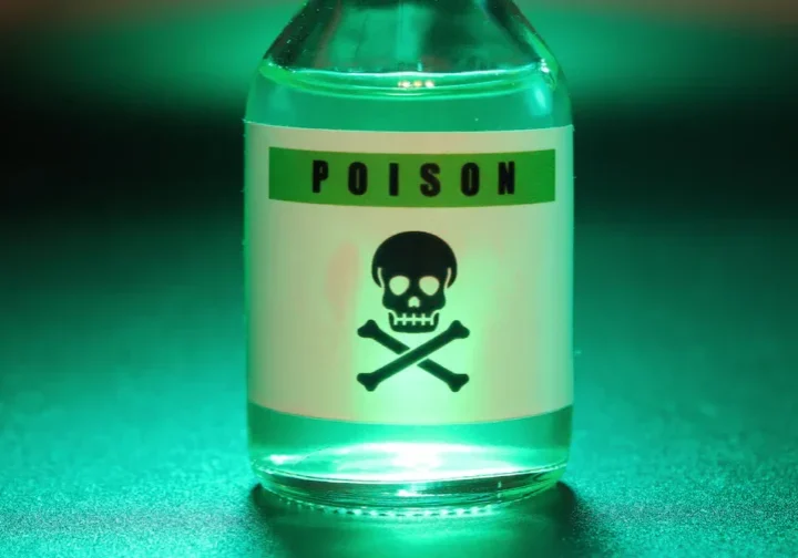 A bottle of green liquid with a skull and crossbones, showcasing the evolution of assassination techniques.